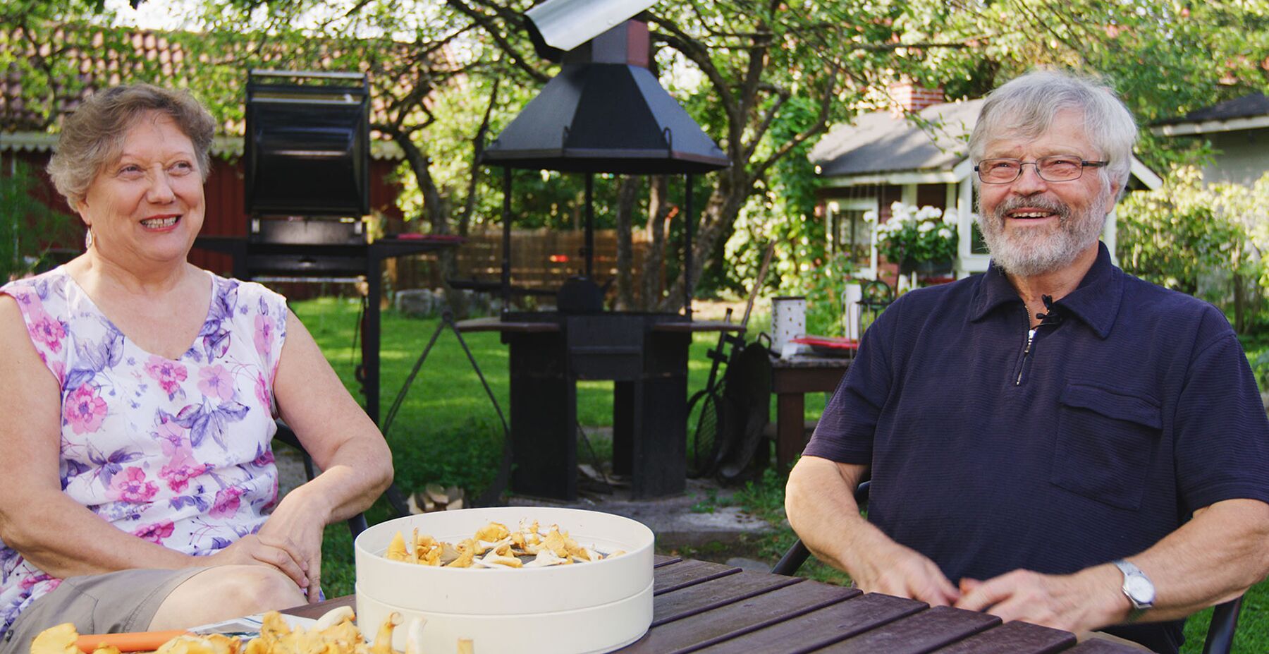 Ritva och Markku sitter i trädgården.